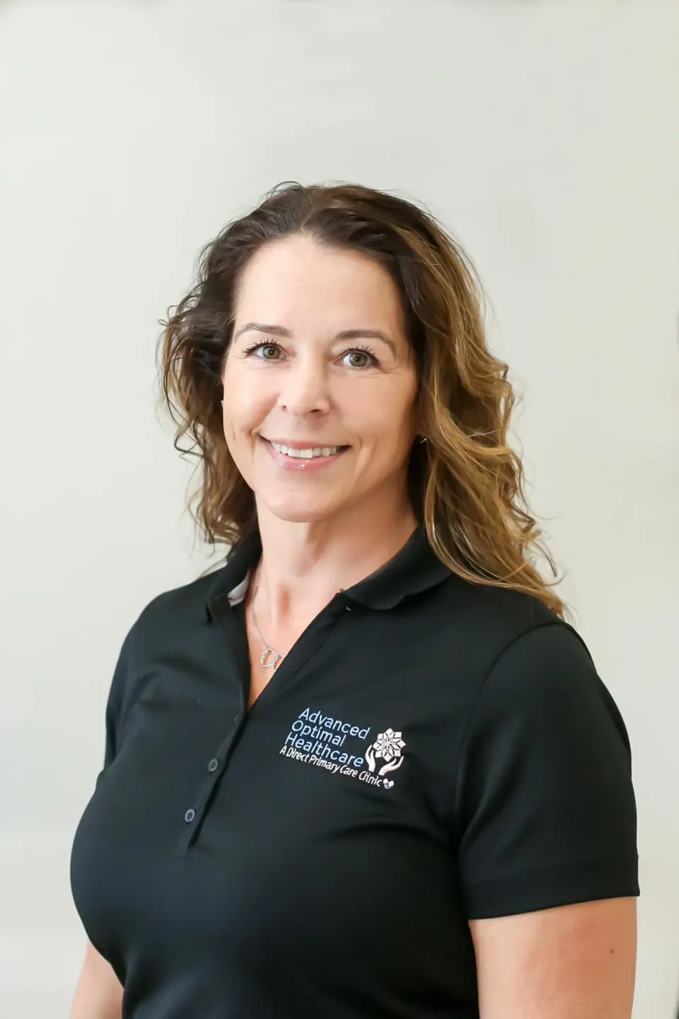 Danielle Cooney, Office Administrator at Advanced Optimal Healthcare, greeting members in Lutz, FL