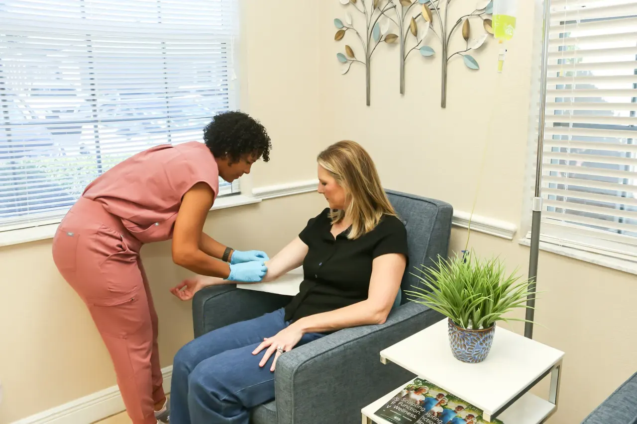 IV therapy drip being administered to a seated patient at Advanced Optimal Healthcare in Lutz, FL